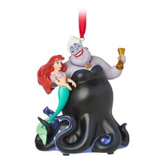 the little mermaid is sitting on top of an octopus ornament