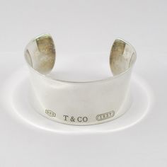 Featured Is This Classic Designer Tiffany & Co. Sterling Silver Classic Wide Cuff Bracelet 7" - 1 1/4" Wide 48.08 Grams Metal: 925 Sterling Silver Stamped: Tiffany & Co. 925 Total Weight: Approx. 48.08 Grams Wrist Size: Fits Approx. 7" Dimensions: Approx. 1 1/4" Wide Ref#: 630-09317 Lf Sterling Silver Cuff Bracelet Tiffany & Co., Jewelry Tiffany, Wide Cuff Bracelets, Tiffany Co Jewelry, Wide Cuff, Tiffany & Co., Womens Jewelry Bracelets, Cuff Bracelet, 925 Sterling Silver