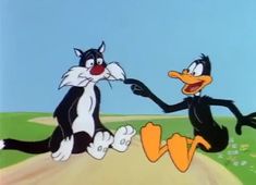 two black and white cartoon cats playing with each other on a dirt road in front of a blue sky