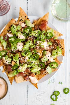 a white plate topped with nachos and guacamole