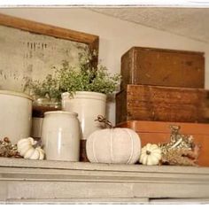 a shelf filled with lots of white vases and other decorative items on top of it