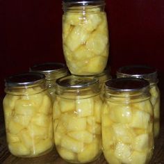 several jars filled with pickles sitting on top of a table