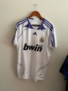 a soccer jersey hanging up on a wall