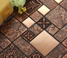 a close up of a tile floor with flowers on the ground in front of it