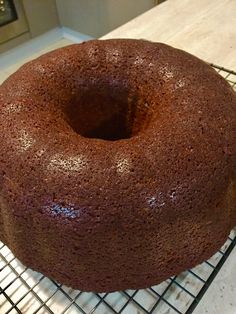 a chocolate cake sitting on top of a cooling rack