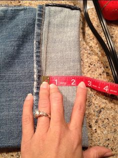 someone is measuring their jeans with a tape