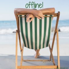 a woman is sitting in a chair on the beach with her arms crossed over her head