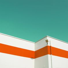 an orange and white striped building against a blue sky