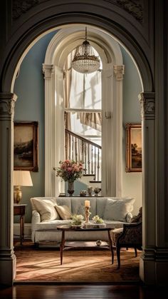 a living room filled with furniture and a chandelier