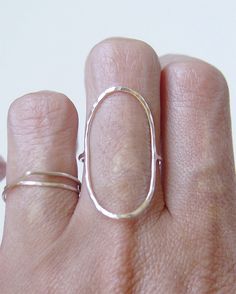 This stunning ring features a oval open circle band of 14K gold fill that wraps around your finger reminiscent of planet Saturn. Stylish and elegant. Perfect for everyday wear. Please specify your ring size and material at the checkout convo section. These rings are made to order. My QUALITY: Gold filled pieces contain 100+ times more real gold than gold plated pieces. They are durable and tarnish resistant. Gold filled pieces are a high quality, affordable alternative to solid gold for people w Modern Oval Stackable Rings With Polished Finish, Hand Forged Modern Everyday Ring, Modern Hand Forged Everyday Ring, Silver Hammered Oval Ring, Minimalist Oval Sterling Silver Stackable Rings, Oval Silver Hammered Ring, Simple Oval Sterling Silver Rings, Hand Forged Oval Ring, Modern Hand Forged Open Band Ring