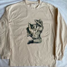 a white long sleeved shirt with an image of a cat on it