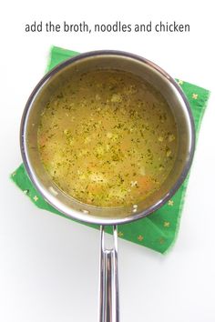 a pan filled with broth sitting on top of a green napkin