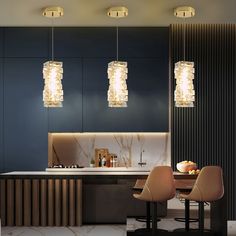 the modern kitchen is decorated with gold and glass pendants hanging from the ceiling, along with two bar stools