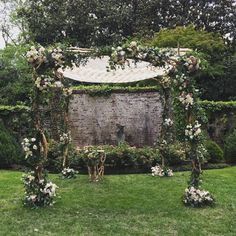 an outdoor ceremony setup with flowers and greenery