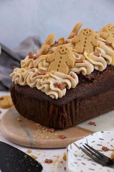 a piece of chocolate cake with white frosting and cookies on top