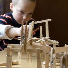 a young child playing with wooden toys