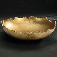 a gold bowl sitting on top of a table