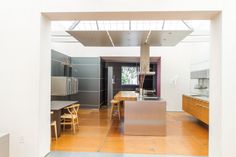 an open kitchen and dining room with wood flooring