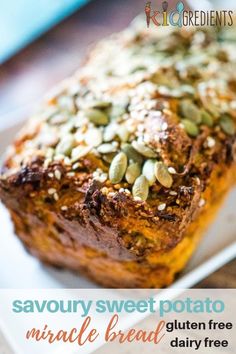 a loaf of bread topped with nuts on top of a white plate