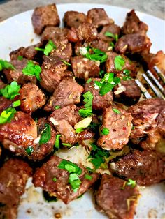 a white plate topped with meat and veggies