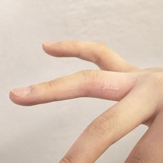 a person's left hand with the word love written on it, in white ink