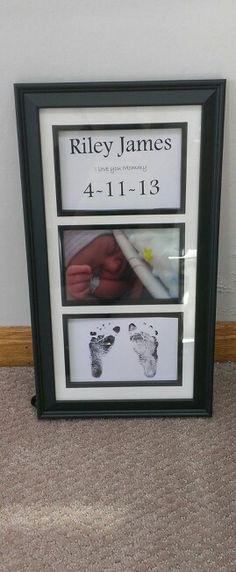 a baby's hand and foot prints are displayed in a frame on the floor