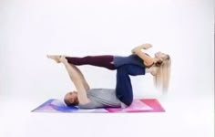 a man and woman doing yoga poses on their stomachs in front of a white background