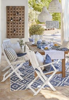 an outdoor dining area with blue and white decor