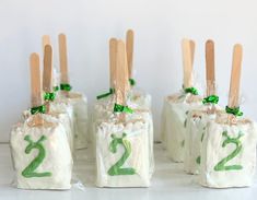 four bags with wooden sticks sticking out of them and numbers on them, all wrapped in plastic