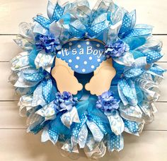 it's a boy blue and white mesh wreath with handprinted baby feet