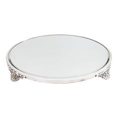 a round glass table with silver accents on the top and bottom, sitting against a white background