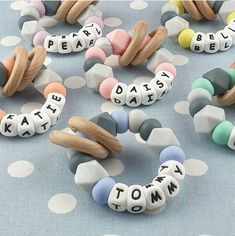 several beads with words written on them sitting on a polka dot tablecloth, next to each other