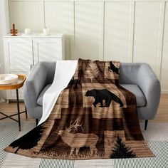 a brown and black bear blanket sitting on top of a chair next to a table