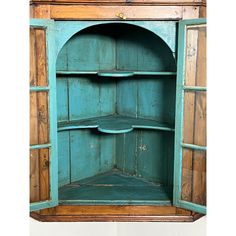 an old blue wooden cabinet with shelves and drawers