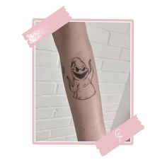 a small tattoo on the arm of a person with a slotty in it's mouth