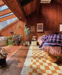 a bedroom with wood paneling and plants on the floor