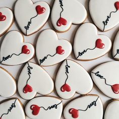 many decorated cookies are arranged in the shape of hearts