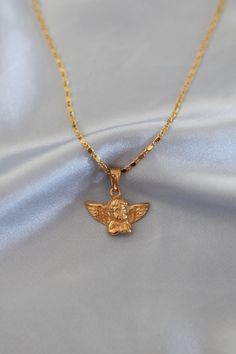 "You're heaven sent, baby. Angel charm on a dainty bar chain. ✧ 18k gold plated ✧ cherub charm measures 23x15mm ✧ lobster clasp closure ✧ nickel + lead free ✧ lengths: 14\"/35.5cm (choker), 16\"/40.6cm, 18\"/45.7cm (model wears 16\") ✧ handmade with love from Oahu, Hawaii More designs on https://preciousbykate.com, use code WELCOME for a discount ✧ care instructions: https://www.preciousbykate.com/jewelry-care" Baby Angel Necklace, Gold Angel Necklace, Angelic Jewelry, Cherub Ring, Gold Necklace Unique, Cherub Necklace, Jewelry Angel, Angel Accessories, Birthday Best Friend