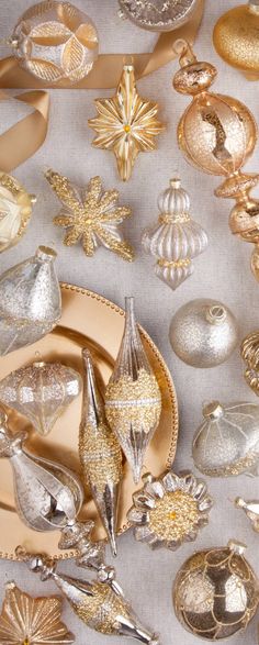 a table topped with lots of different types of christmas decorations on top of a white cloth