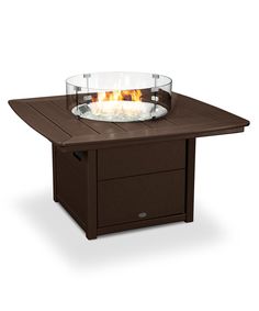 an outdoor table with a glass bowl on it's top and fire pit in the middle