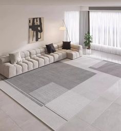 a modern living room with white and gray furniture