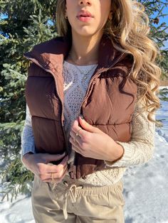 This wonderfully warm cropped puffer vest keeps out cold drafts while looking super stylish. Its relaxed fit feels roomy and can be worn over larger layers. A must have for your wardrobe. Details: - Model is 5'6" and is wearing size small - Zipper closure - Cropped fit - Care: Hand wash and hang to dry Brown Puffer Vest, Cropped Puffer Vest, Brown Puffer, Vests For Women, Puffer Vest, Stand Collar, Puffer, Collar