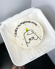 a cake in a plastic container with writing on it