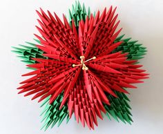 an origami christmas tree decoration made out of red and green paper