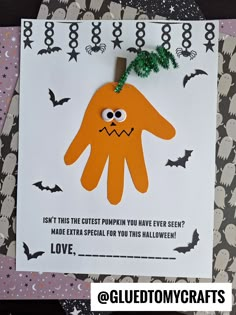 a halloween card with an orange monster on it