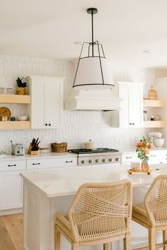 two wicker chairs sit at the kitchen island