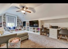 a living room filled with furniture and a flat screen tv on top of a wall