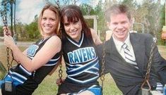 two women and a man in cheerleader outfits posing for a photo on a swing