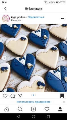 cookies decorated with blue and white icing are arranged in the shape of heart - shaped hearts