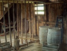 an old barn with wooden walls and buckets